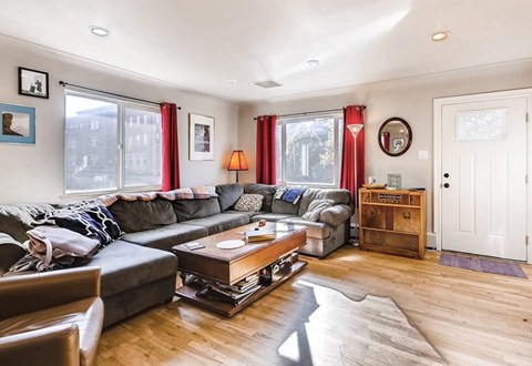 A living room with a grey couch and a coffee table.