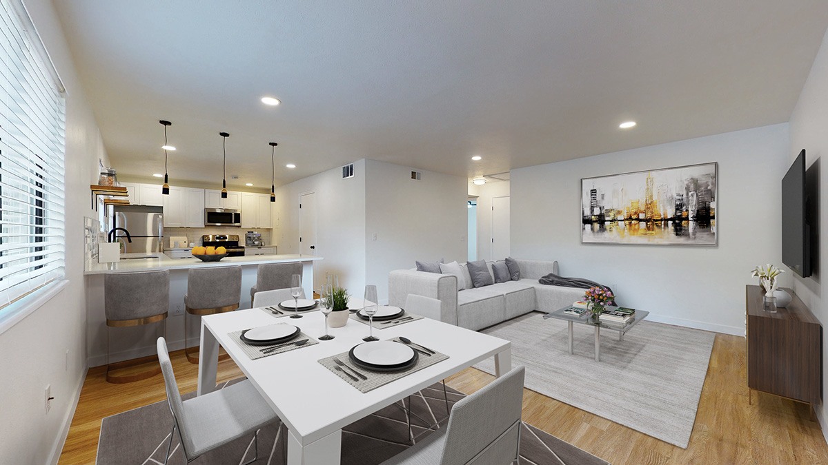 A modern dining room with a white table and chairs.