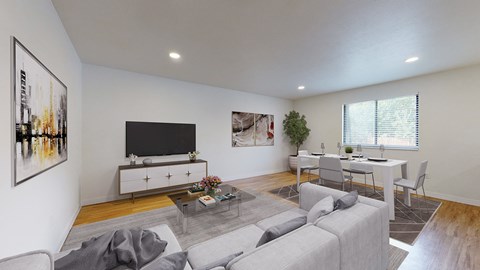 A living room with a grey couch and a white coffee table.