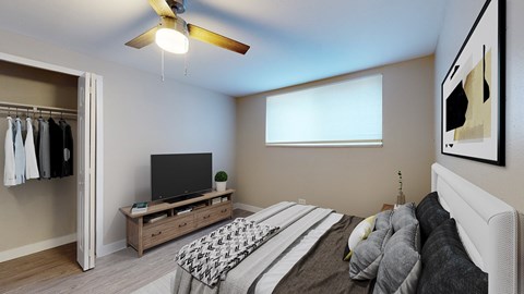 A bedroom with a bed, a television, and a wardrobe.