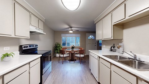 A kitchen with white cabinets and a black stove top oven.