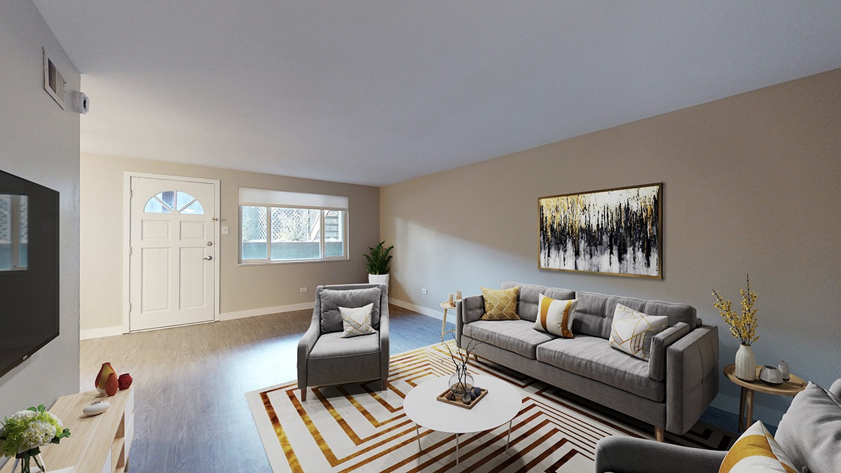 A living room with a grey couch, a coffee table, and a painting on the wall.