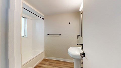 A white bathroom with a toilet and a shower.