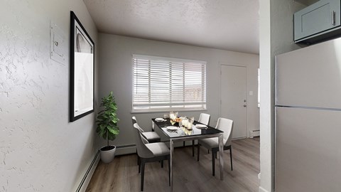 A dining room with a table set for four.