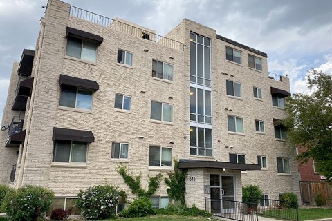 A large building with a balcony on the second floor.