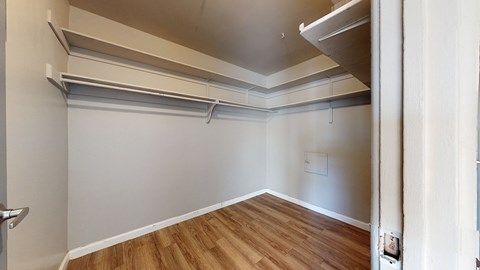 A room with a white wall and a wooden floor.