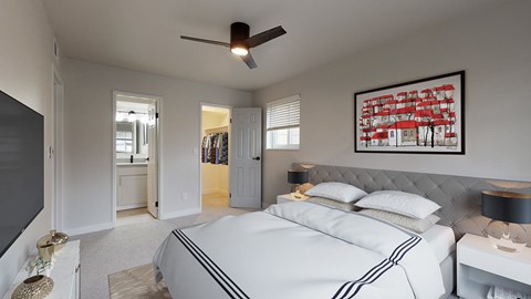 A bedroom with a large bed and a ceiling fan.
