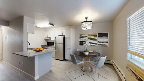 A modern kitchen with a dining table and chairs.