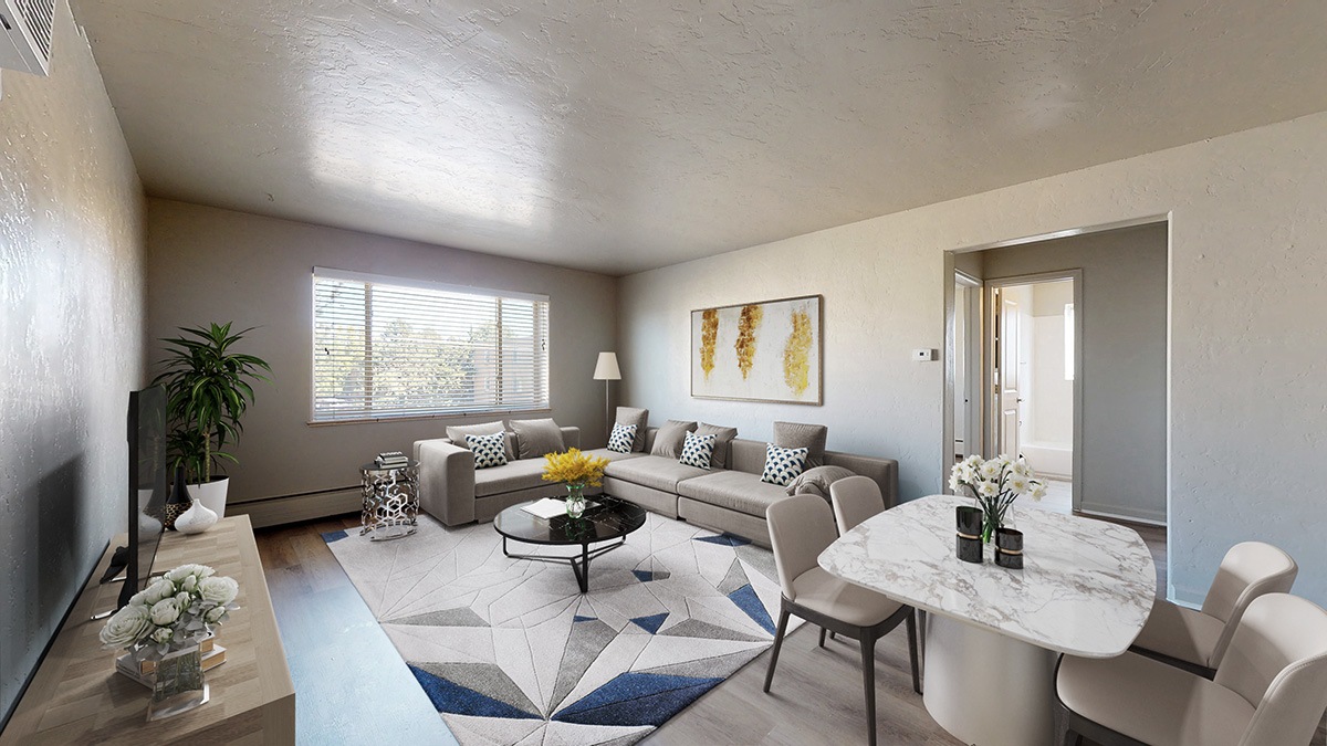 A living room with a couch, chairs, and a coffee table.