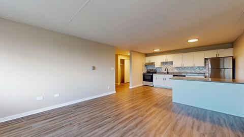 A spacious kitchen with a countertop and cabinets.