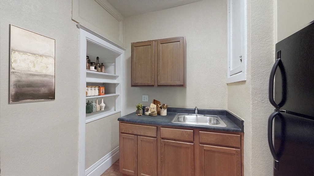 a kitchen with a sink and a refrigerator
