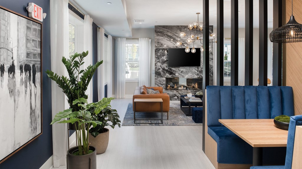 a living room with blue furniture and a fireplace