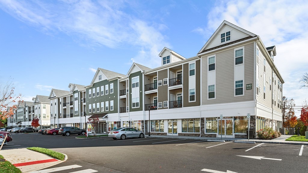 a large apartment building on the corner of a city street