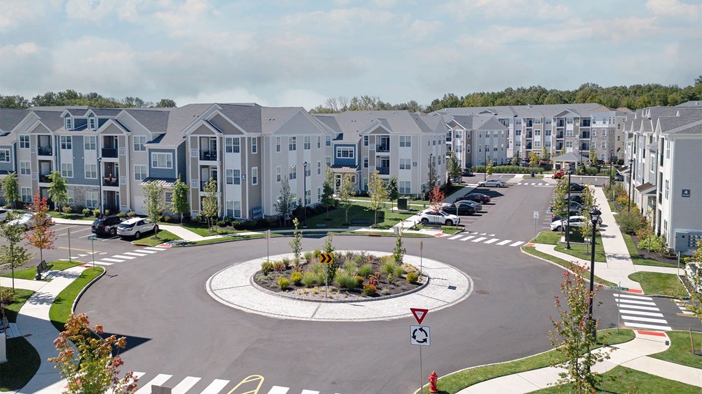 an aerial view of an empty parking lot at an apartment complex