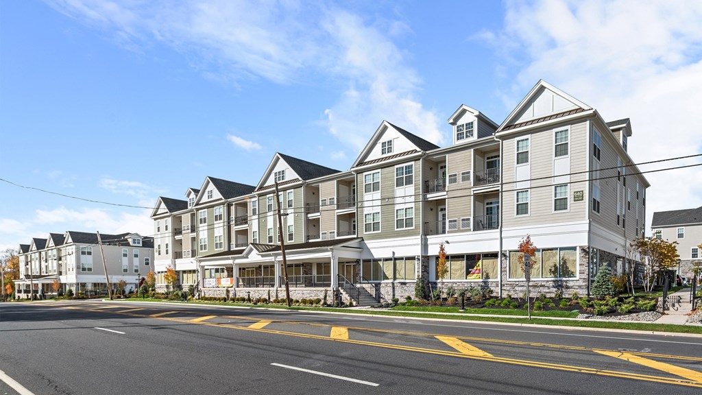 a row of apartment buildings on the side of a street