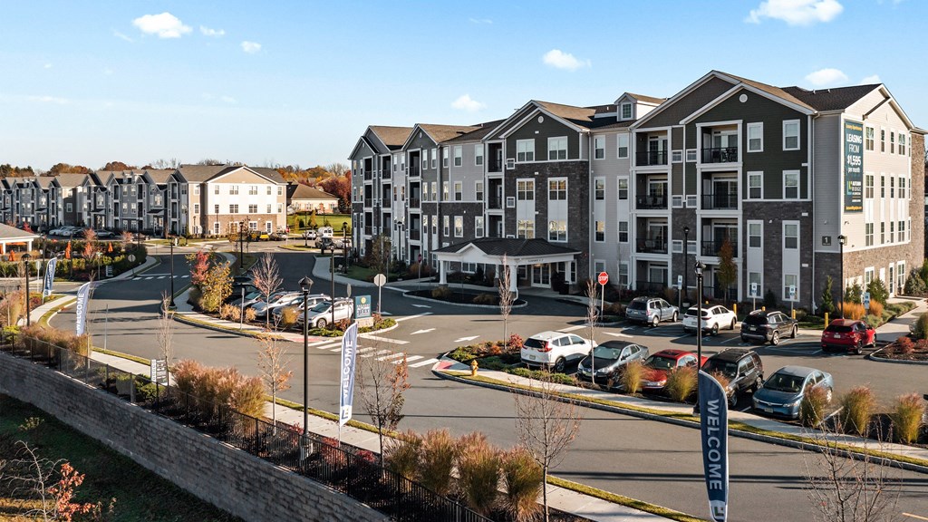 an aerial view of an apartment complex with cars parked in a parking lot