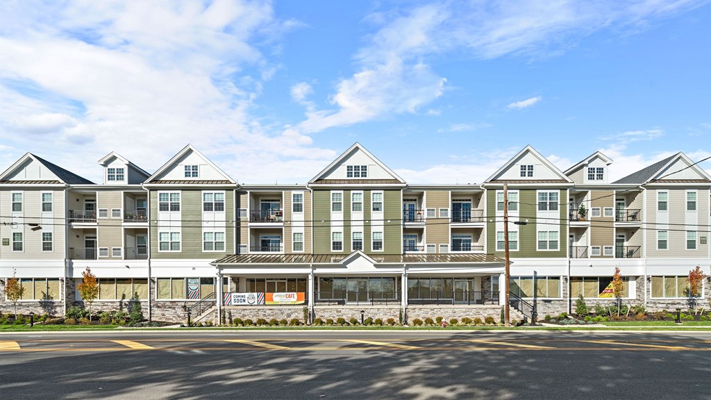 a large apartment building with a street in front of it