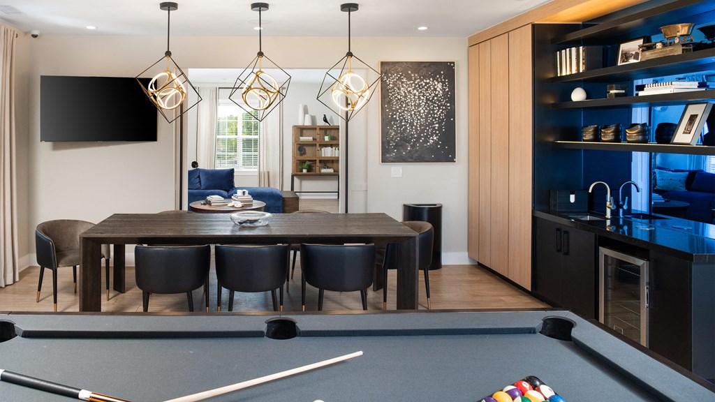 a dining room with a table and chairs and a pool table