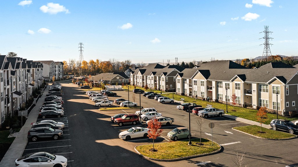 an aerial view of a neighborhood with cars parked in a parking lot