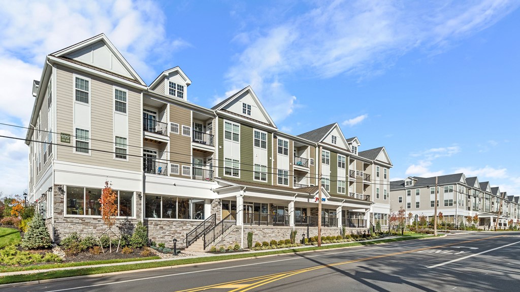 a row of apartment buildings on the side of a street