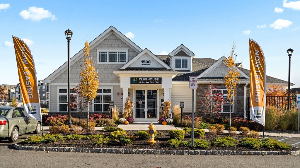 the exterior of a building with banners in front of it