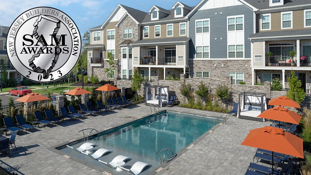 an image of a swimming pool in front of an apartment building
