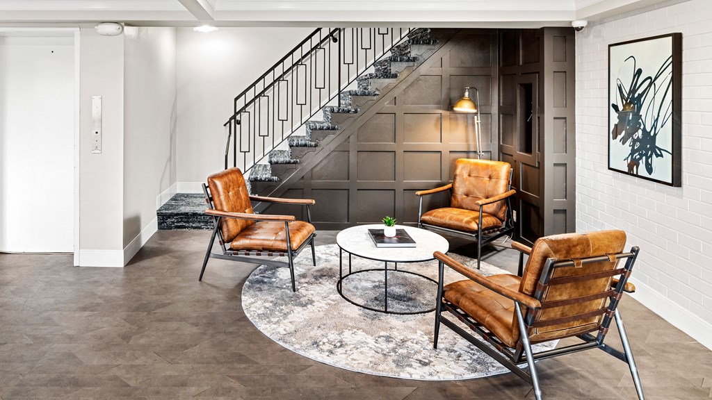 a living room with leather chairs and a table