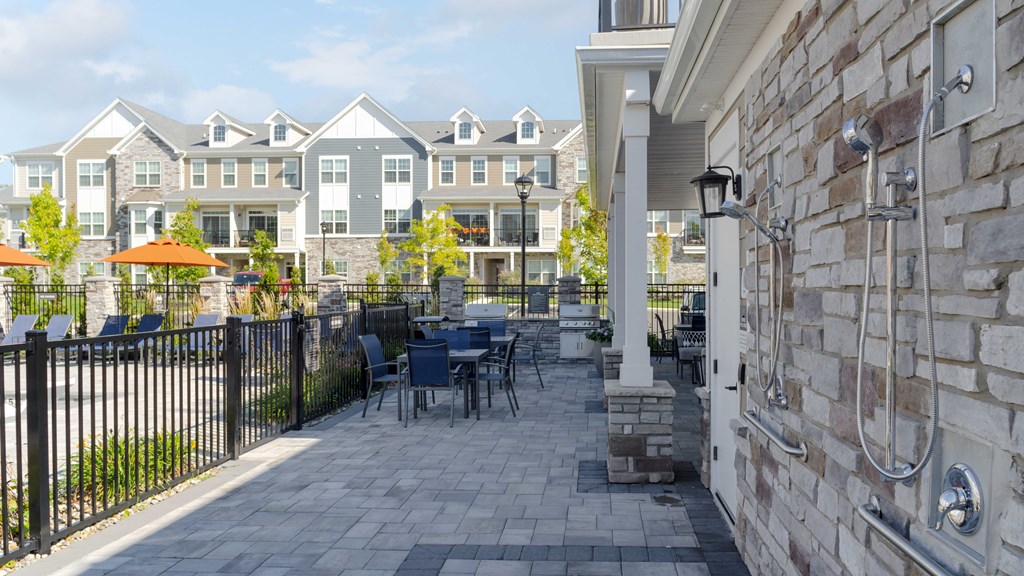a patio with tables and chairs outside of a building