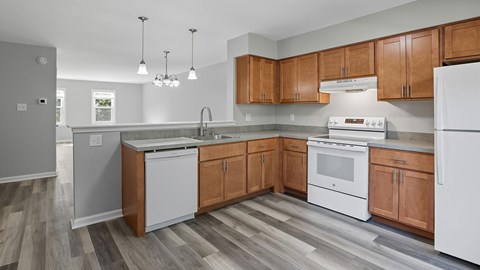 A kitchen with wooden cabinets and white appliances.