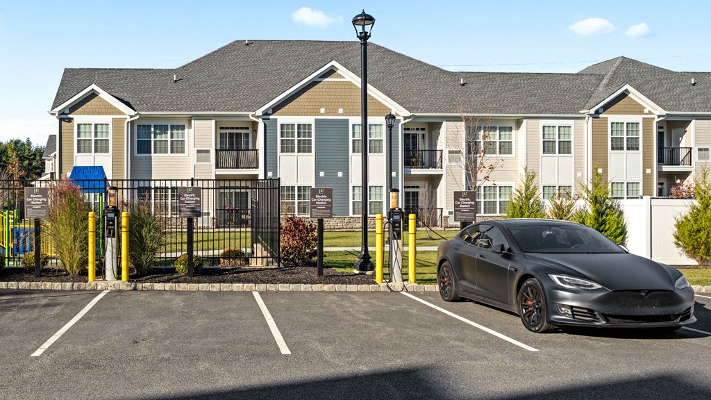 a car parked in a parking lot in front of an apartment building