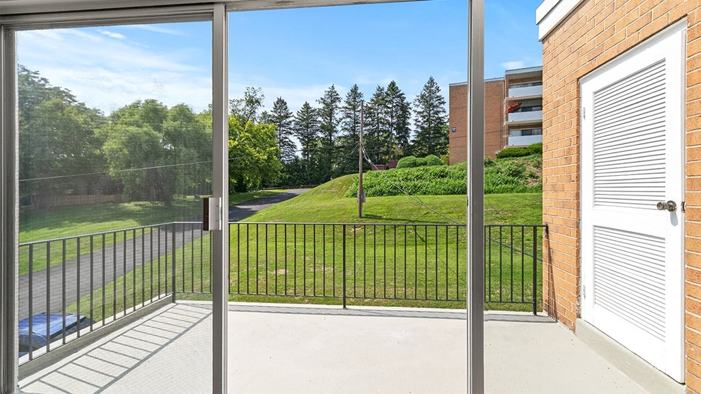 the view of the yard from the balcony of an apartment building