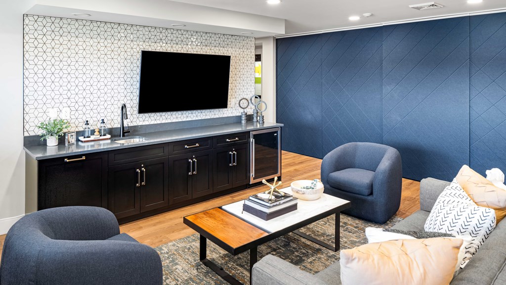 a living room with a kitchen and a television