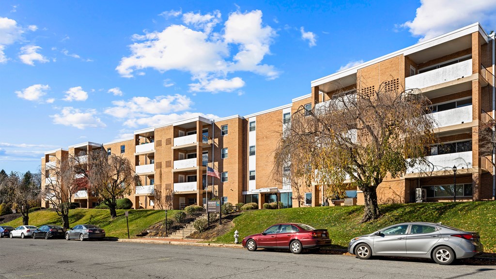 an apartment building with cars parked in front of it