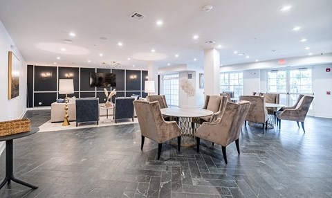 a dining room with a table and chairs in a lobby