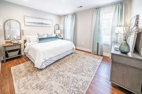 a bedroom with a bed and a dresser and a window