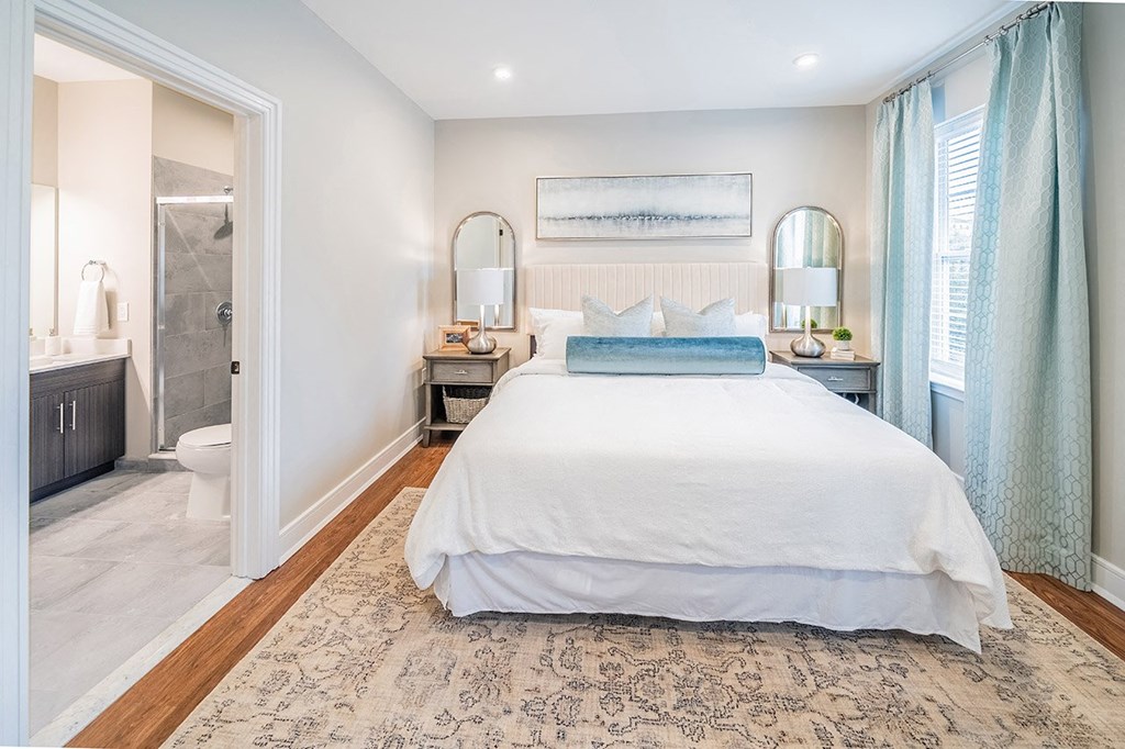 a bedroom with a bed and a bathroom with a shower