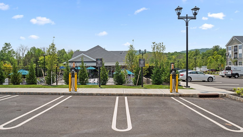a parking lot with a gate and a building in the background