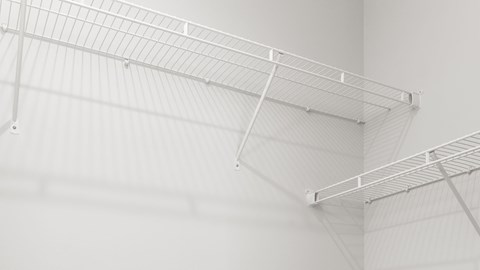 A white shelf is mounted on the wall.