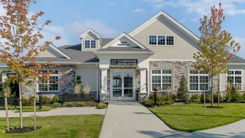 the front of a house with a sidewalk in front of it