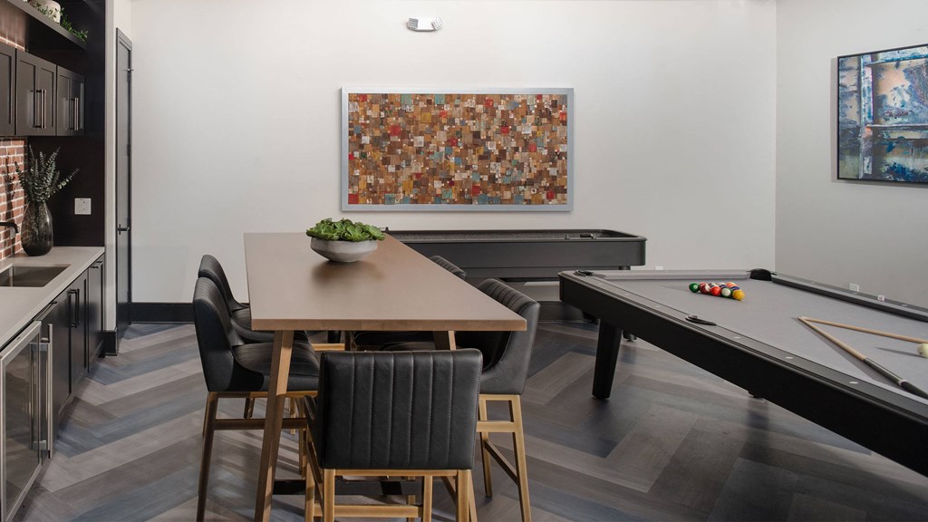 a dining room with a table and a pool table