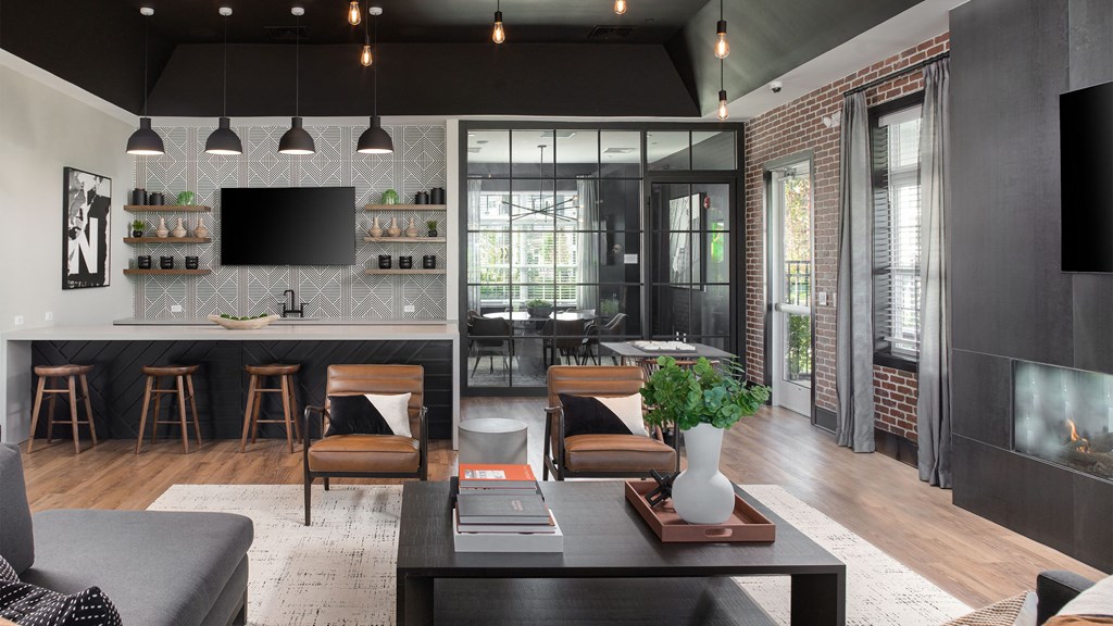 a living room with a kitchen and a large window