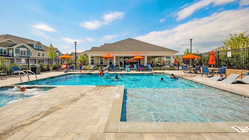 our apartments have a resort style pool with chairs and umbrellas