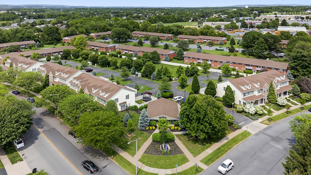 A bird's eye view of a residential area with houses and cars.