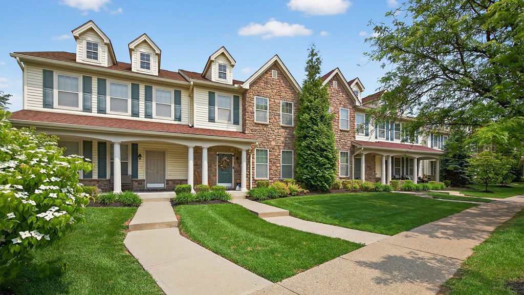 A large house with a red brick facade and white trim.