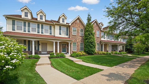 A large house with a red brick facade and white trim.