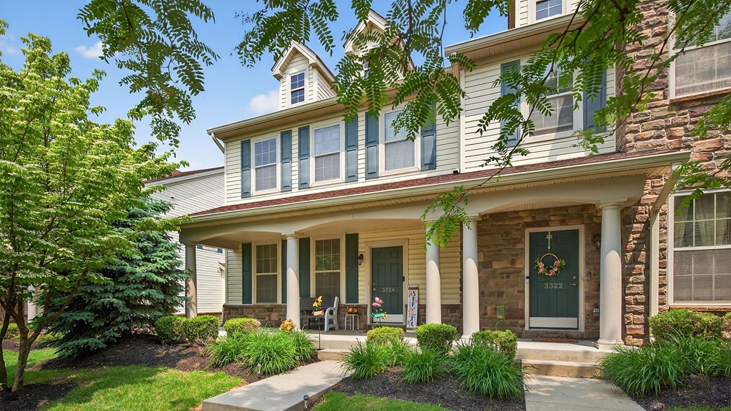 A house with a front porch and a green door.