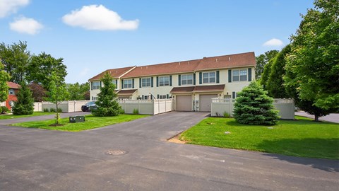 A large building with a parking lot in front.