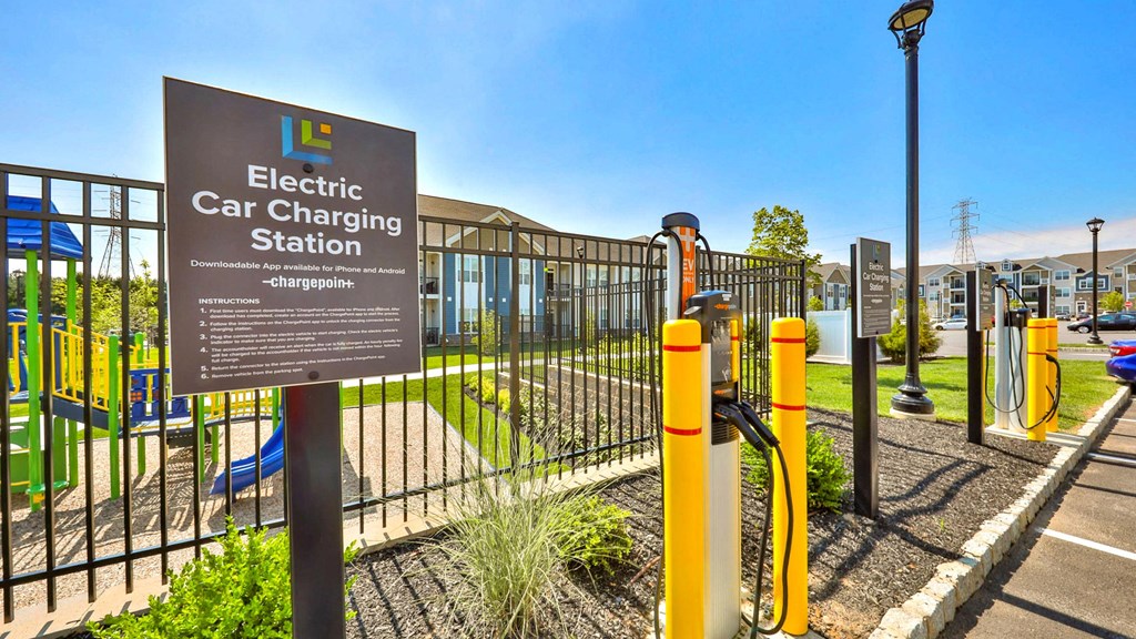 a sign for an electric car charging station at a park