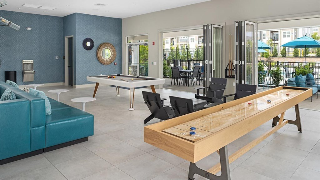 a game room with a pool table and tables