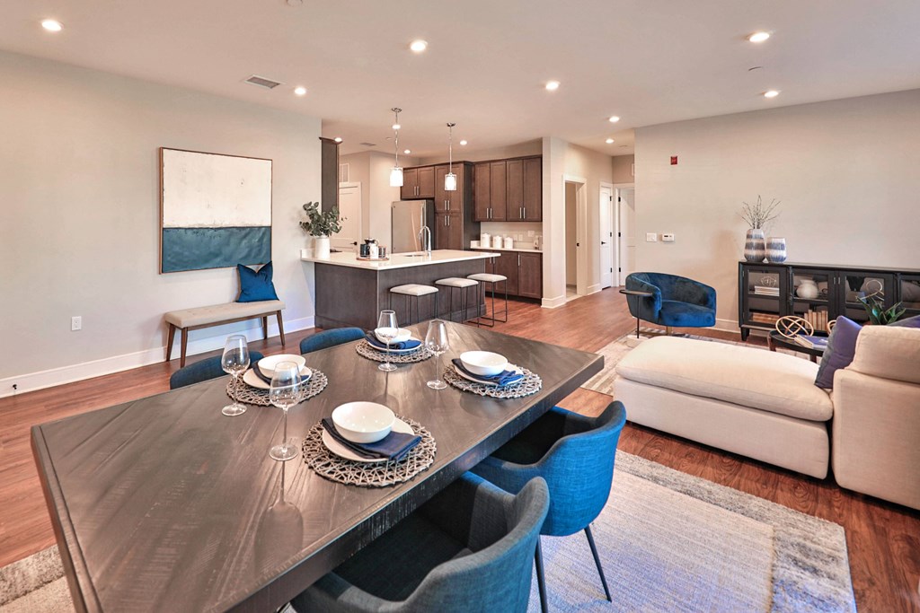 a living room and dining room with a table and chairs